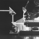 An intense ruby laser light beam penetrates twin prisms during an experiment at North American Aviation’s Autonetics Division, 1965. Despite the brilliance of the beam laser weapons were still a half century from reality.